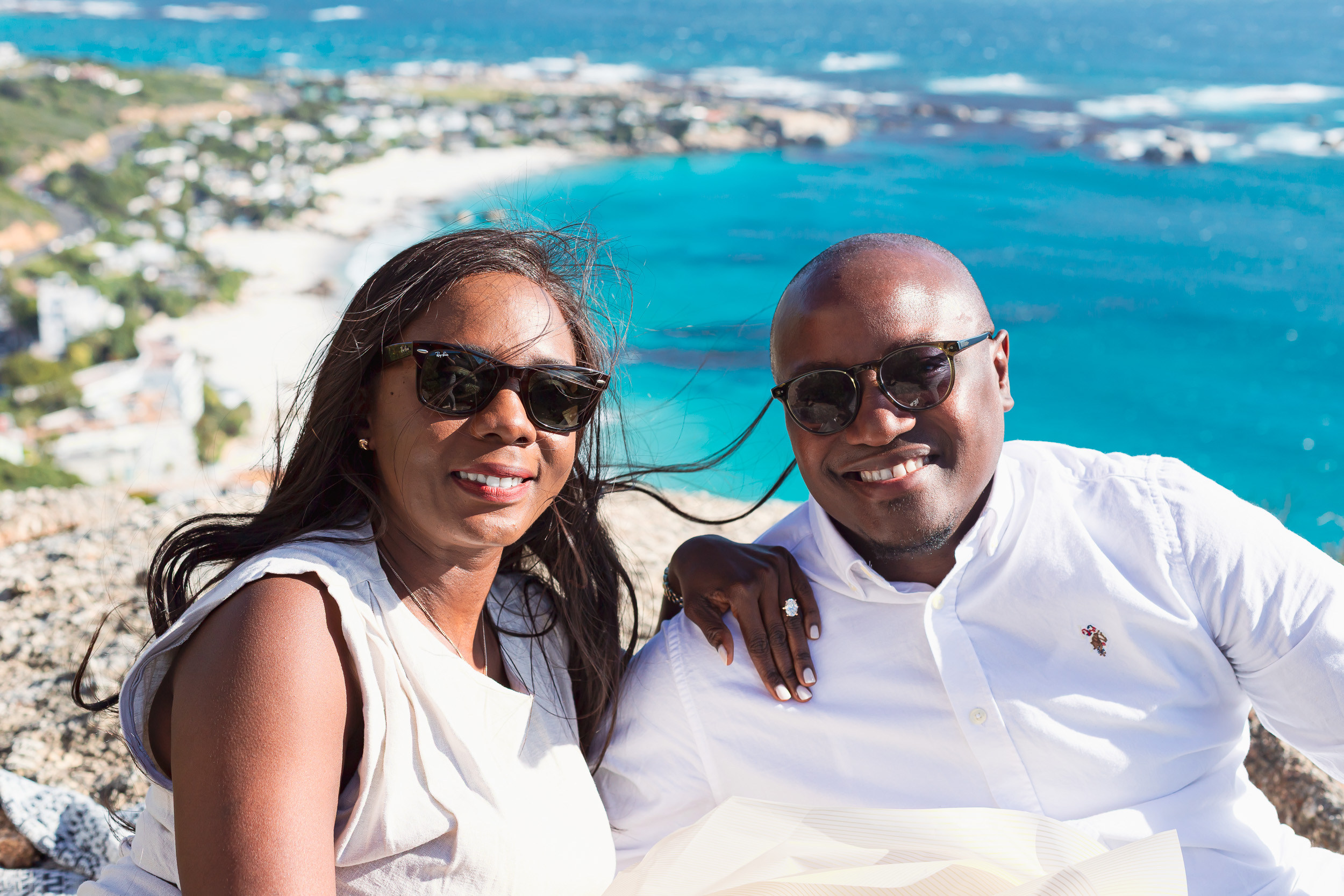 Mulumba and Chilombo smiling together with the sea behind them